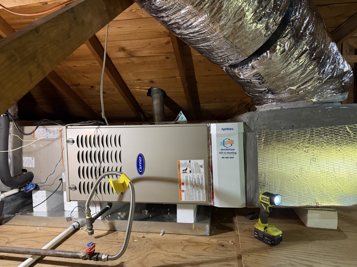Carrier furnace in an attic with a JaviAirFlow label on the filter housing